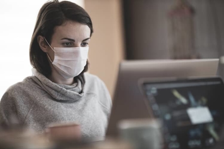Woman works while wearing a medical mask