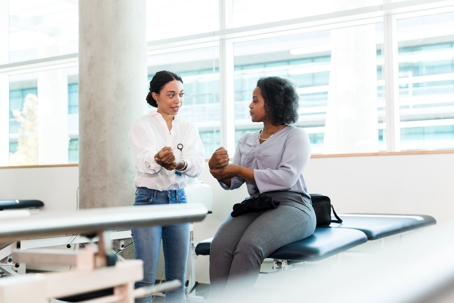 Medical professional helps an injured worker with her wrist injury
