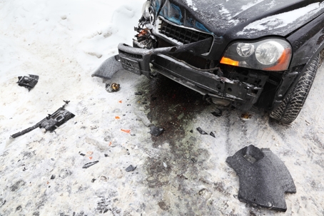 front bumper damaged by car accident in snowy conditions